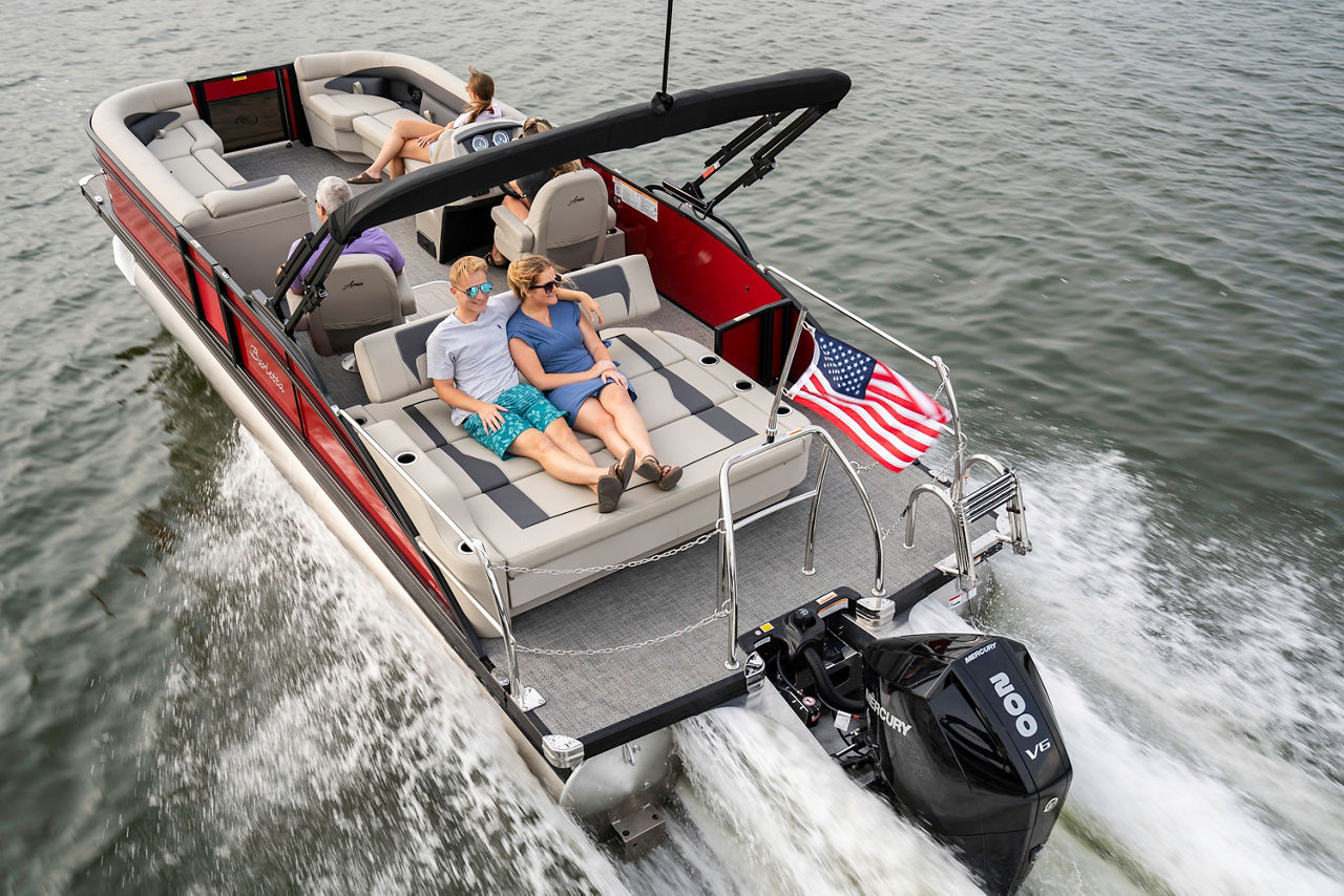 couple sitting in back of moving boat