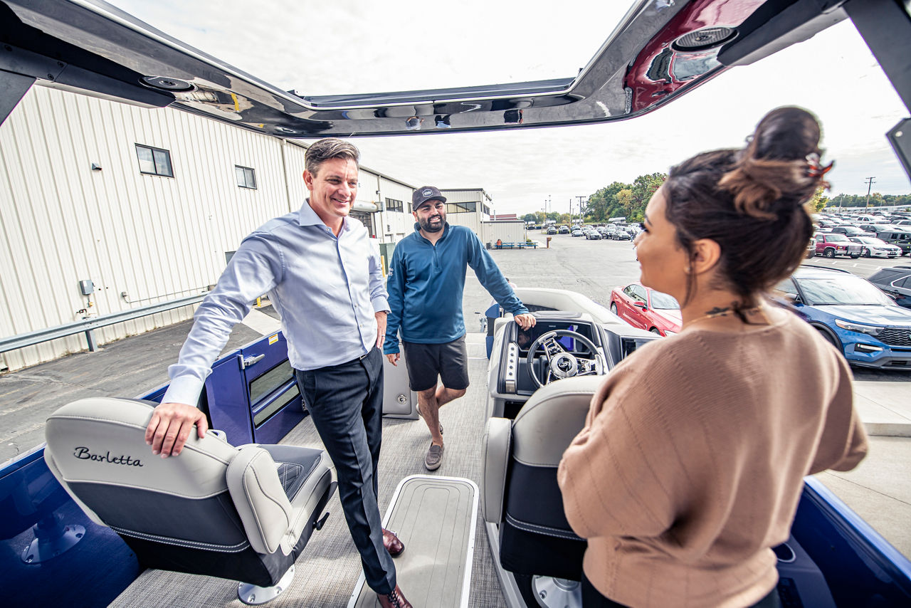 a person talking to a salesperson on a boat