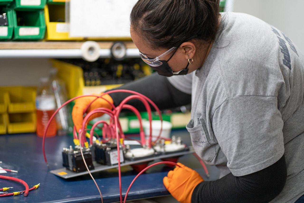 Woman working on electrical board