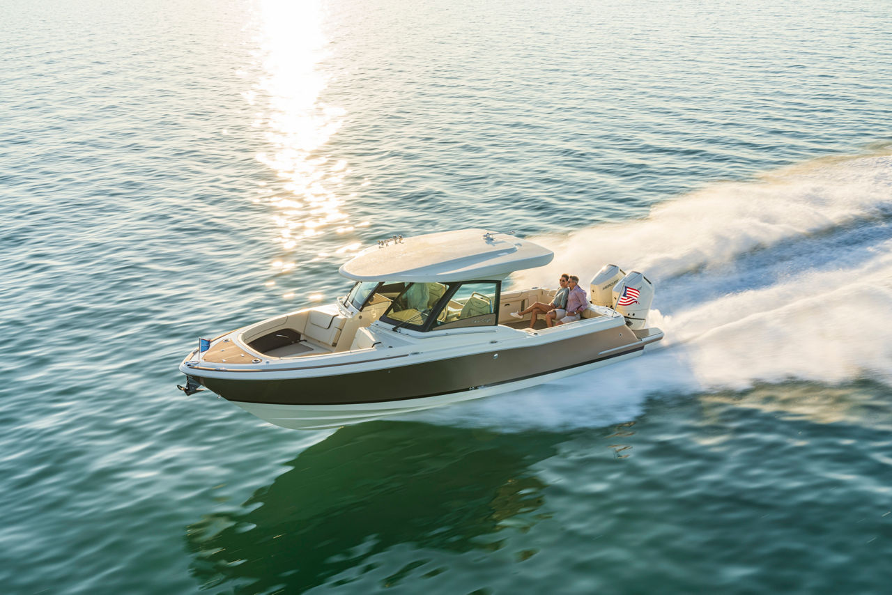 Calypso 32 on the water with a couple sitting in the aft