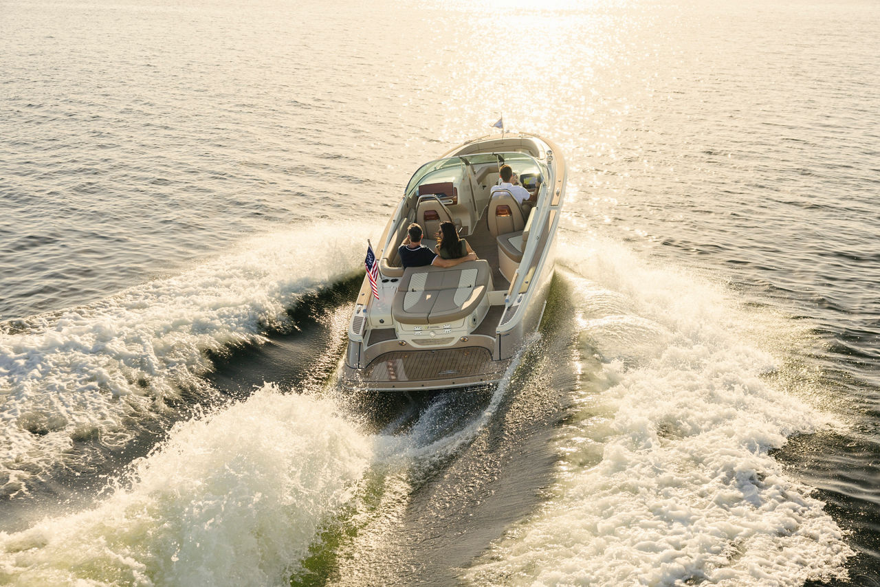 Launch 25 GTe - electric boat riding towards the sunset