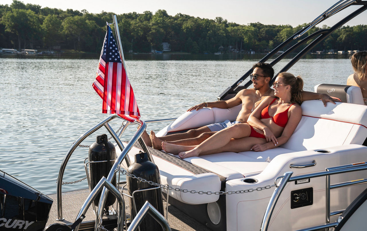 Couple relaxing on back of boat