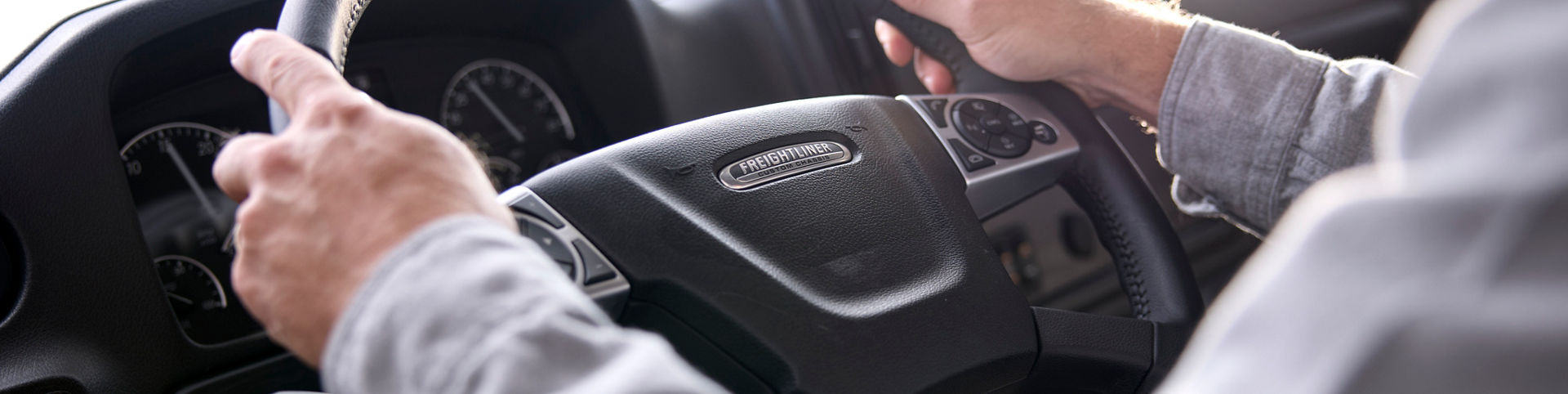 Person driving an RV. Up close image of hands on steering wheel