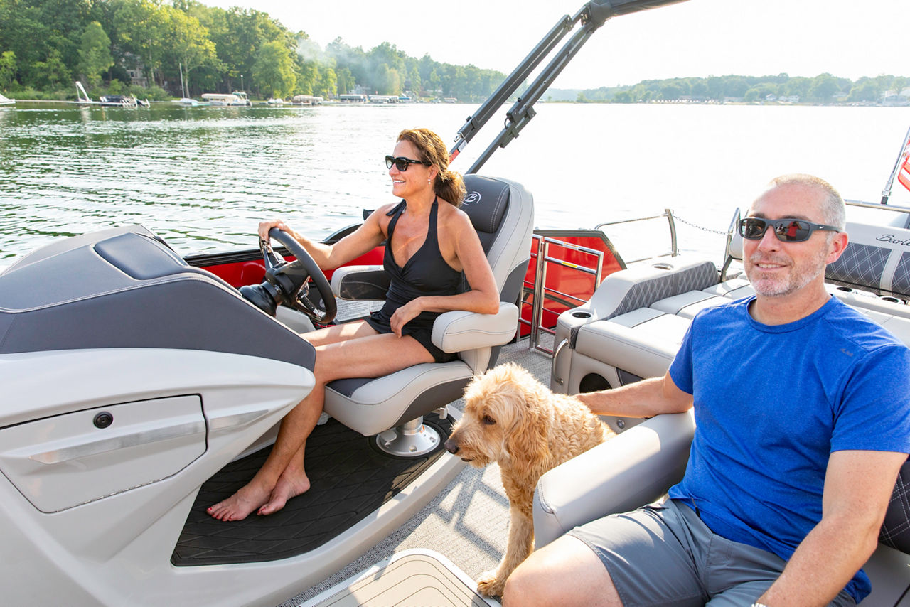 couple with dog in a barletta boat