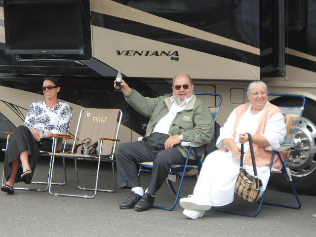 Mahlon Miller and others sitting outside the Newmar Ventana RV