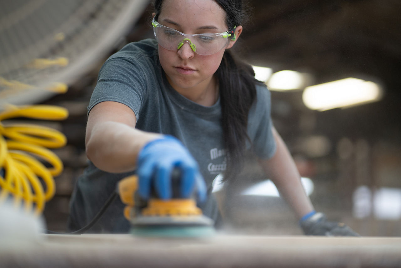 woman sanding cabinets