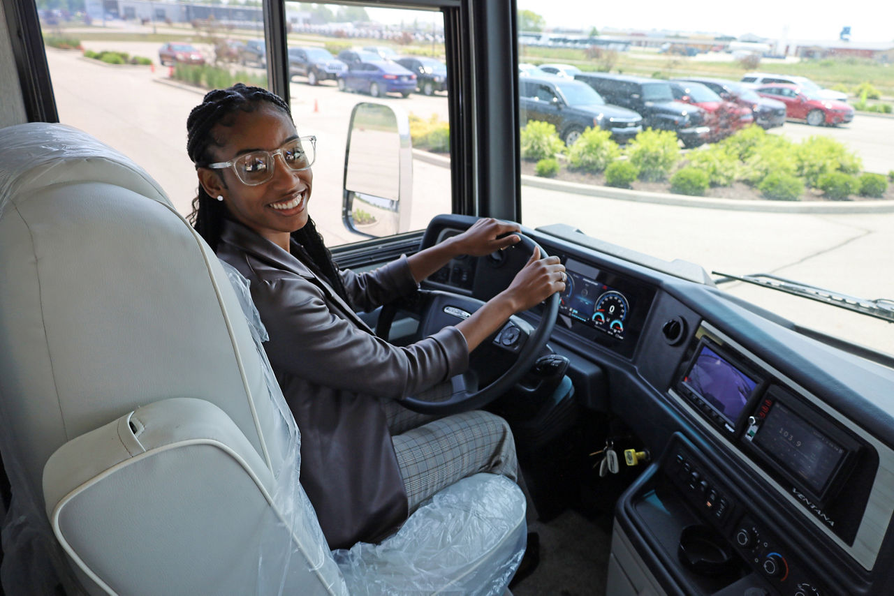 Woman sitting in driver seat of RV