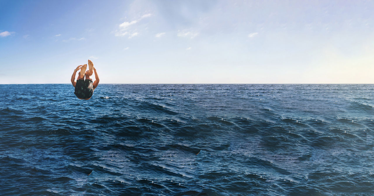 person doing backflip in ocean