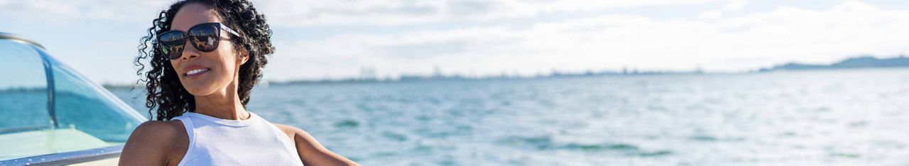 Woman smiling with ocean behind her