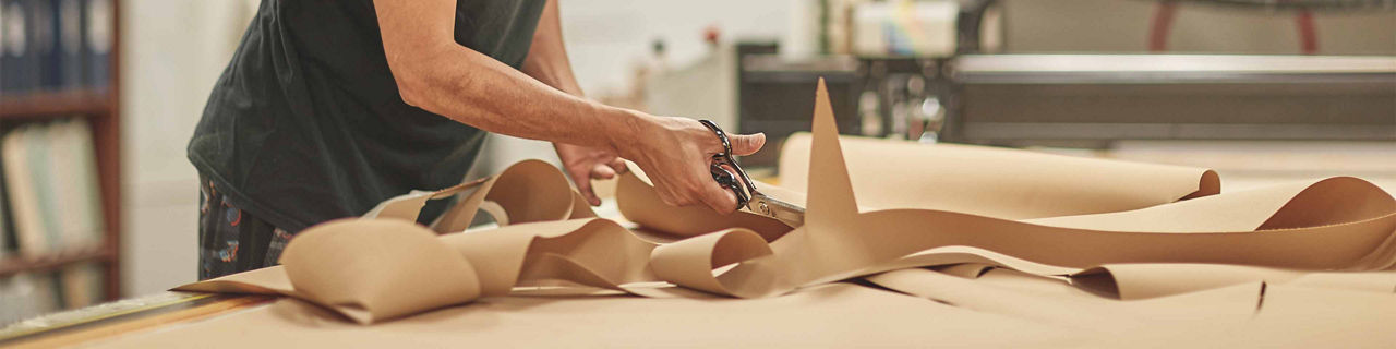 Person cutting material with scissors