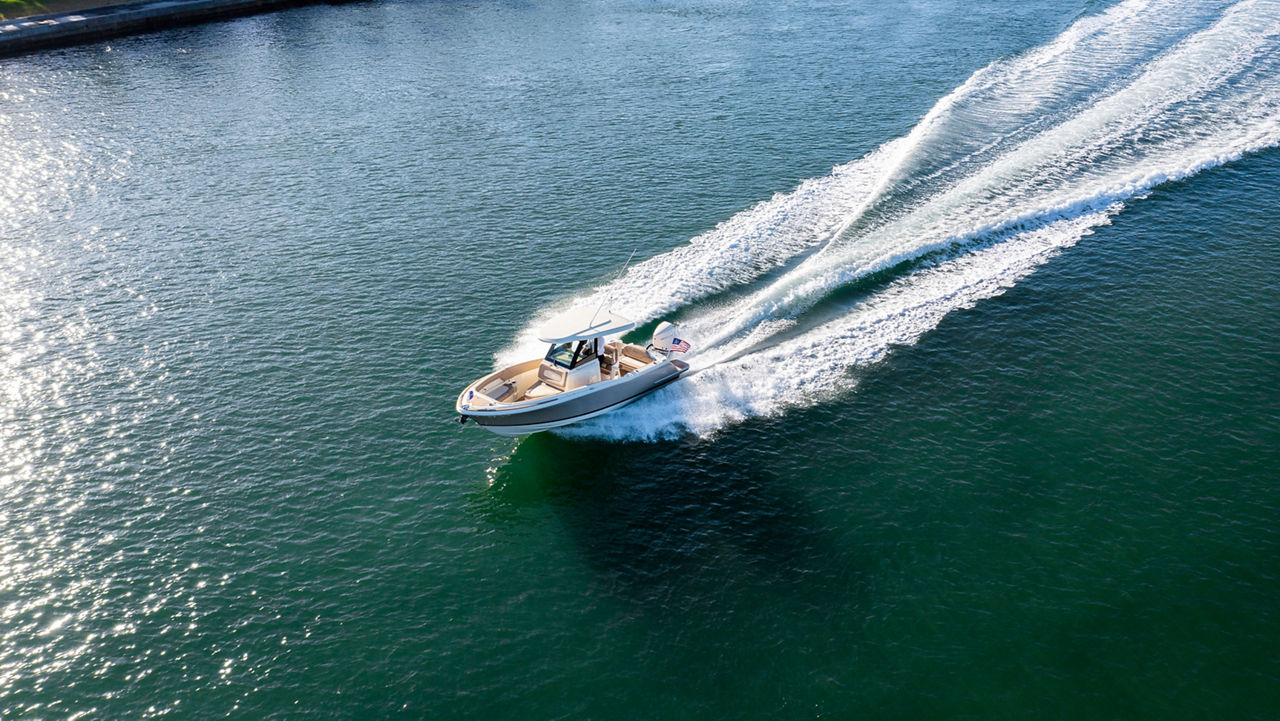 Chris craft boat driving to the right on the water