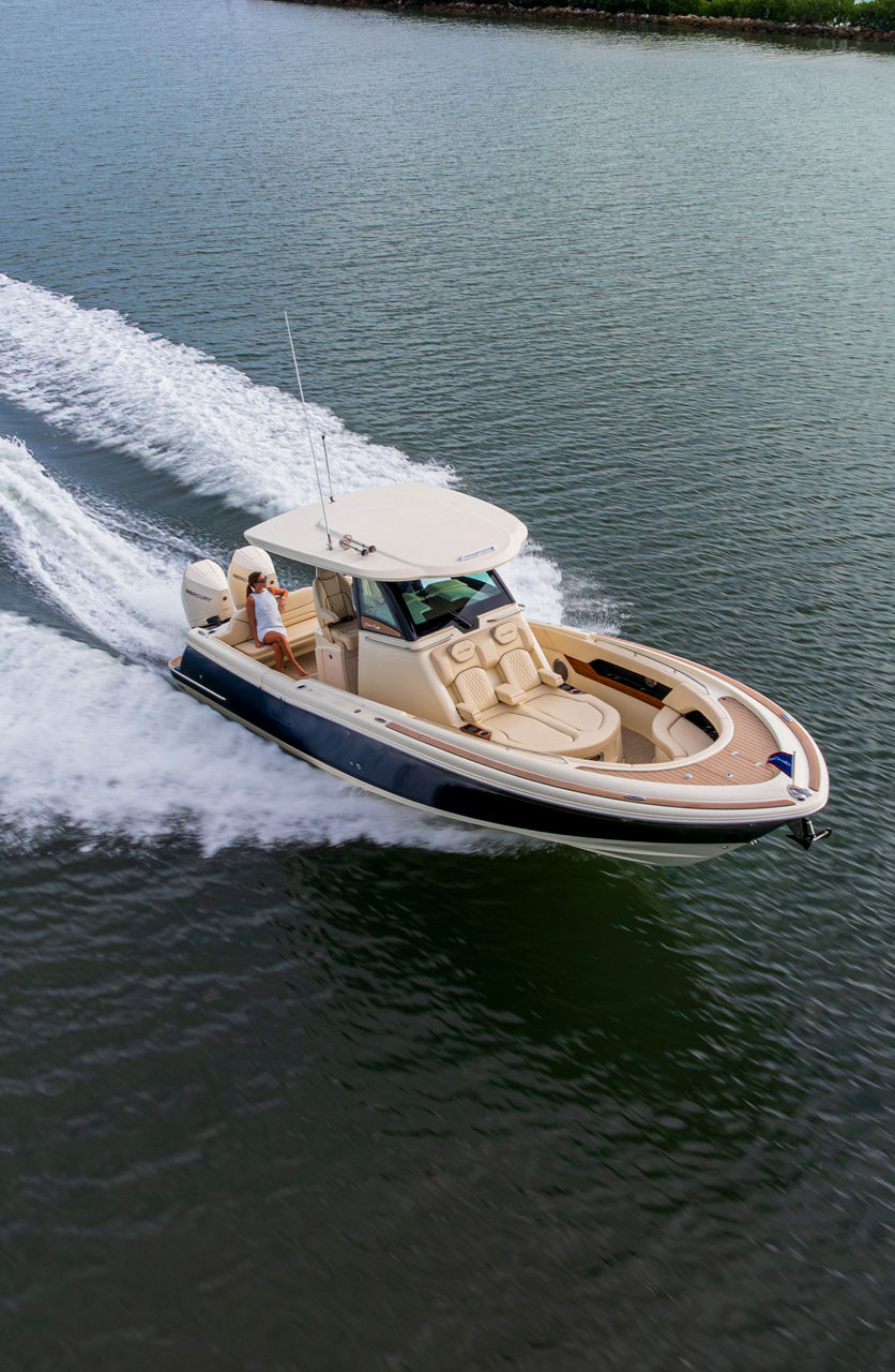 Chris craft boat on the water moving to the left