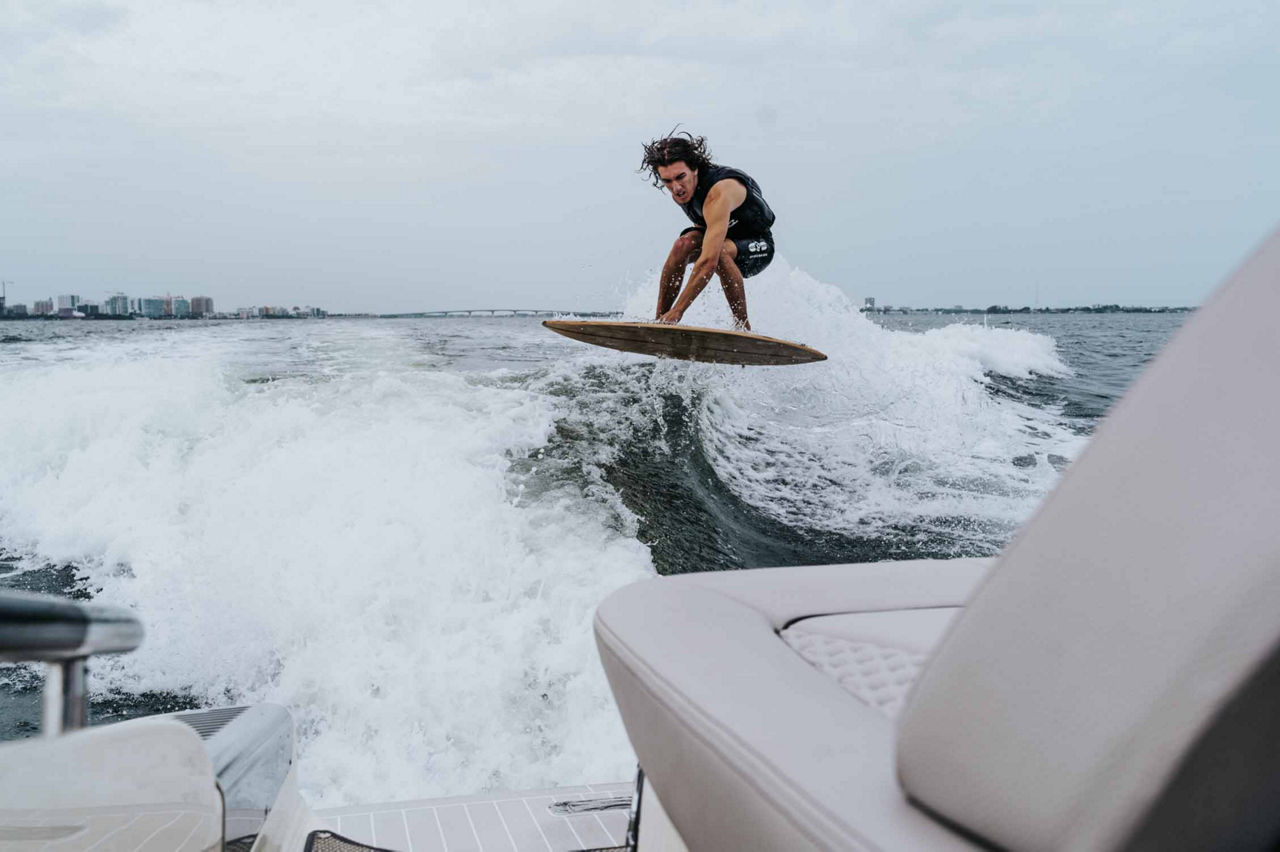 wake surfer behind the Calypso Launch 28 GT model