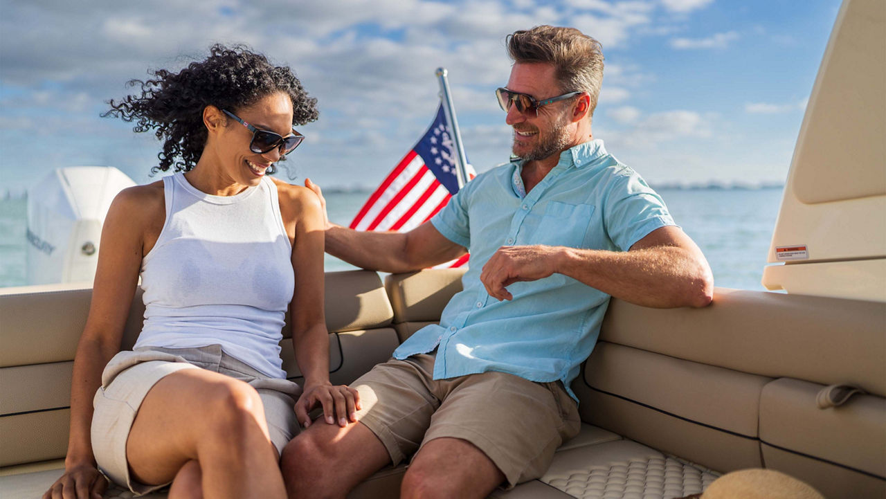 Two people laughing while on a Launch 25 GT boat on the water