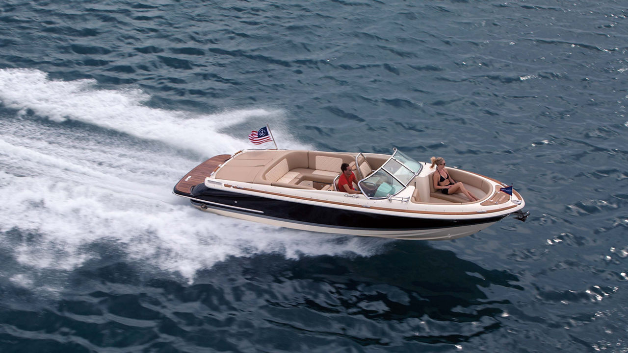 Chris craft boat driving to the right on the water
