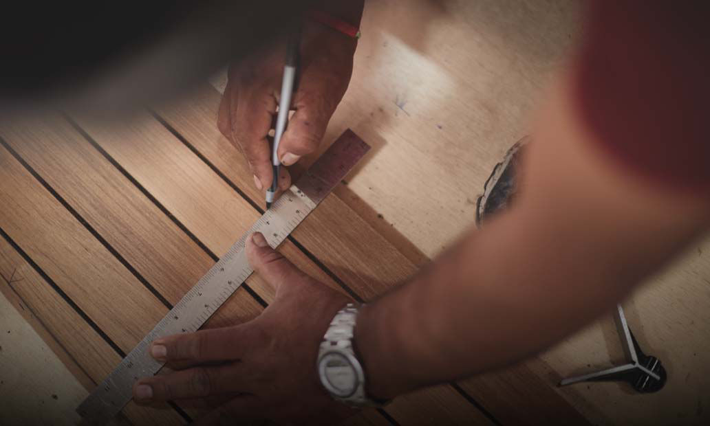 Hands measuring wood