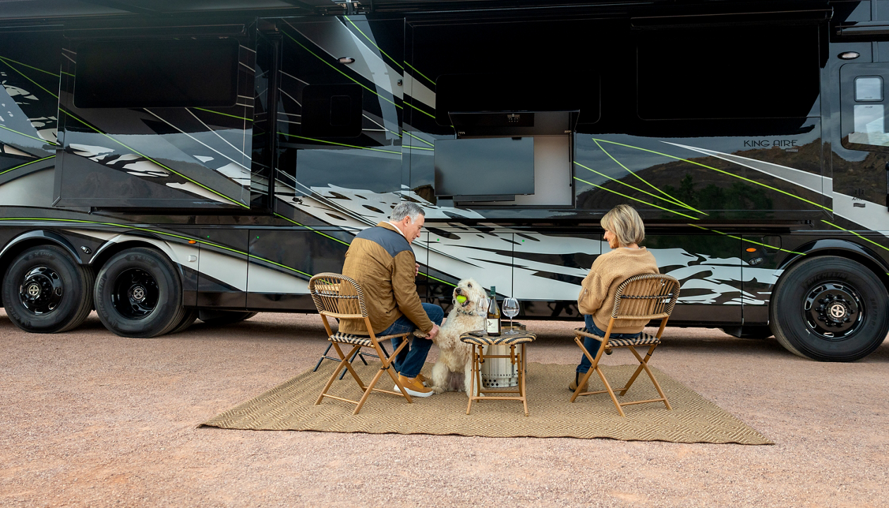 couple sitting out side of coach