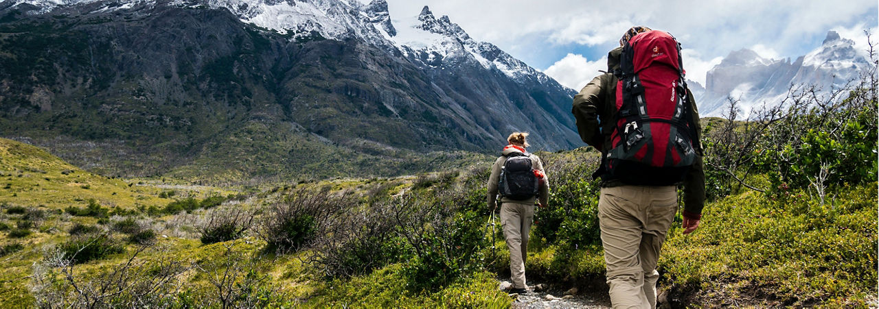 two people backpacking in the mountains 