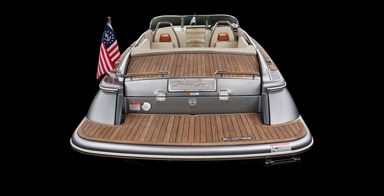 Chris Craft employee measuring wood panels on a boat