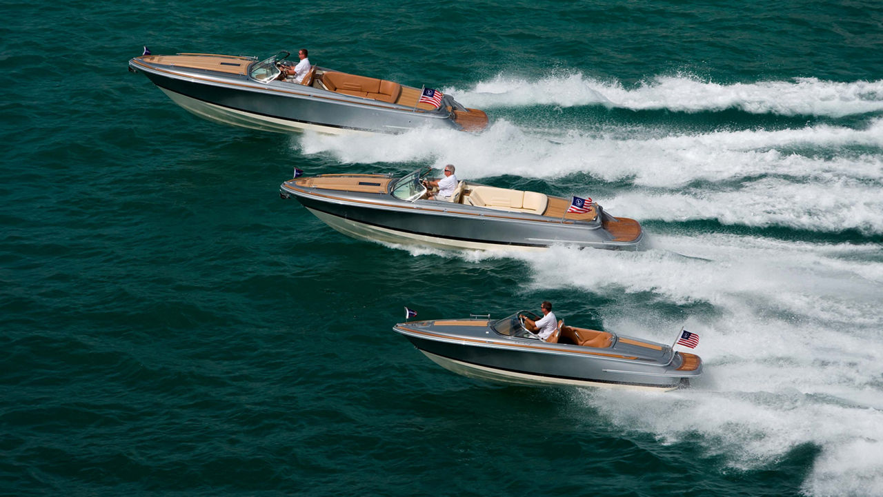 Three chris craft boat driving side by side on the ocean