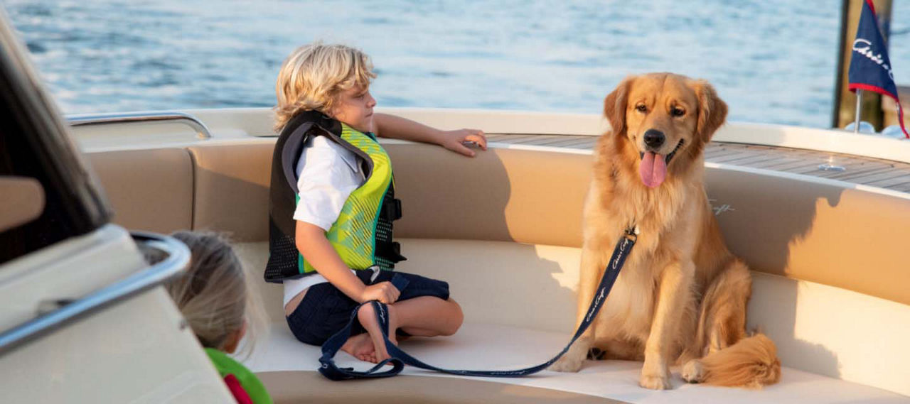 Kid with a dog on a boat